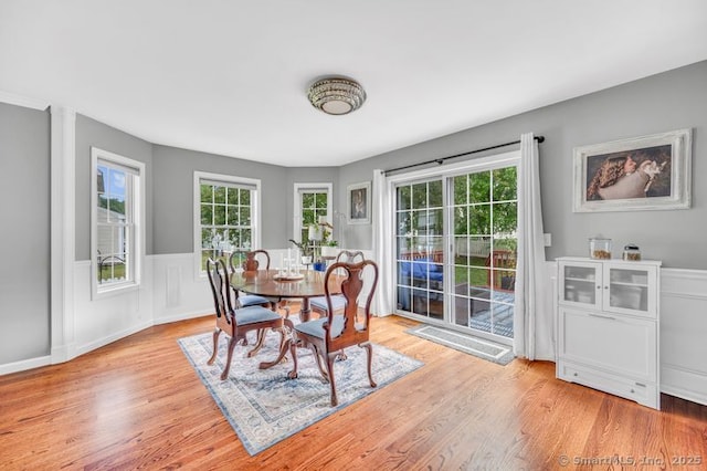 51 Olde Village Cir Unit 51, Wallingford, CT 06492 - dining room featuring plenty of natural light, light wood-style flooring, and a wainscoted wall