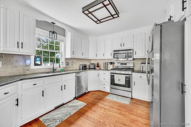 51 Olde Village Cir Unit 51, Wallingford, CT 06492 - kitchen with appliances with stainless steel finishes, white cabinets, and light wood finished floors