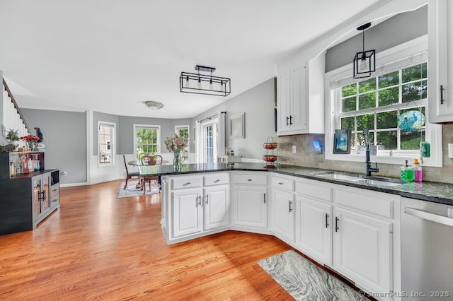 51 Olde Village Cir Unit 51, Wallingford, CT 06492 - kitchen featuring stainless steel dishwasher, light wood finished floors, a peninsula, and white cabinetry