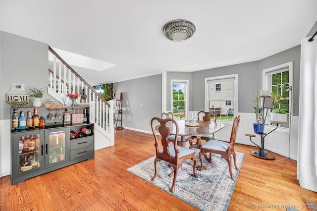 51 Olde Village Cir Unit 51, Wallingford, CT 06492 - dining space with stairs, wood finished floors, a skylight, and wainscoting
