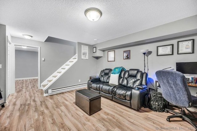 51 Olde Village Cir Unit 51, Wallingford, CT 06492 - living room with baseboard heating, wood finished floors, stairs, and a textured ceiling