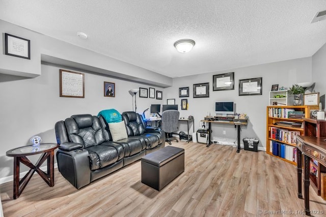 51 Olde Village Cir Unit 51, Wallingford, CT 06492 - living room featuring light wood-style floors, an office area, and a textured ceiling