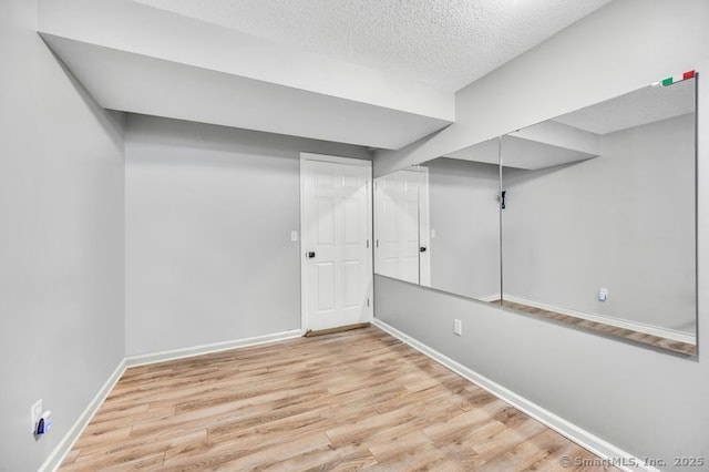 51 Olde Village Cir Unit 51, Wallingford, CT 06492 - finished basement featuring wood finished floors and a textured ceiling