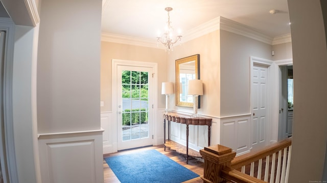 7 Taunton Ln, Newtown, CT 06470 - foyer entrance with a decorative wall, wood finished floors, wainscoting, a chandelier, and ornamental molding