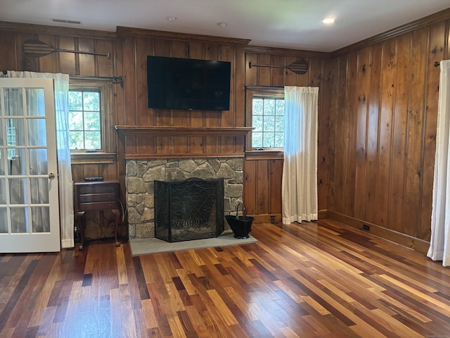 7 Taunton Ln, Newtown, CT 06470 - living area featuring wood finished floors, plenty of natural light, a stone fireplace, wood walls, and crown molding