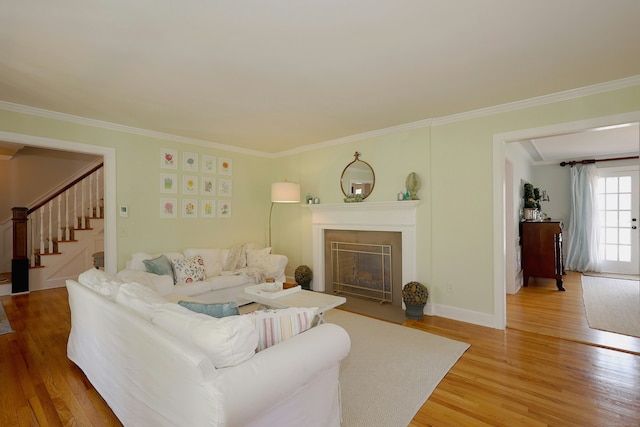37 Giles Hill Rd, Redding, CT 06896 - living room featuring ornamental molding, stairs, light wood finished floors, and a fireplace with flush hearth