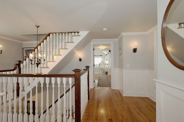 37 Giles Hill Rd, Redding, CT 06896 - hallway with light wood-style flooring, wainscoting, and crown molding