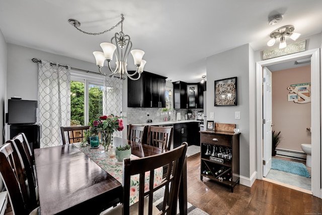 66 Atwood St Apt 16, Plainville, CT 06062 - dining area featuring baseboard heating, dark wood-type flooring, and a chandelier