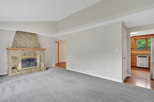 170 Scantic Meadow Rd, South Windsor, CT 06074 - unfurnished living room with carpet, a stone fireplace, and vaulted ceiling