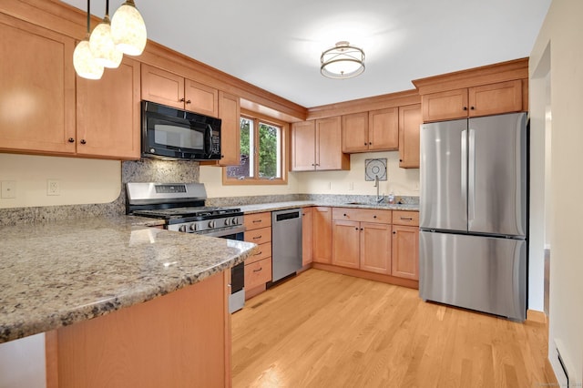 170 Scantic Meadow Rd, South Windsor, CT 06074 - kitchen featuring stainless steel appliances, light wood finished floors, a baseboard radiator, light stone counters, and hanging light fixtures