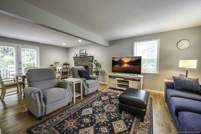 1018 Long Hill Rd, Middletown, CT 06457 - living area featuring a textured ceiling, wood finished floors, recessed lighting, and a fireplace
