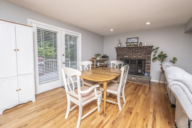 1018 Long Hill Rd, Middletown, CT 06457 - dining space with a fireplace, light wood-style floors, recessed lighting, and french doors