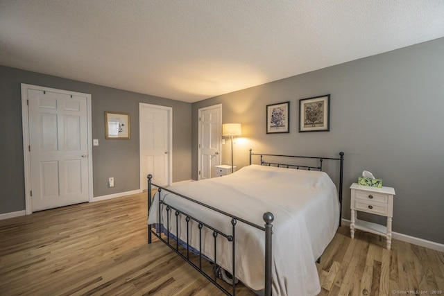 1018 Long Hill Rd, Middletown, CT 06457 - bedroom featuring wood finished floors and a textured ceiling