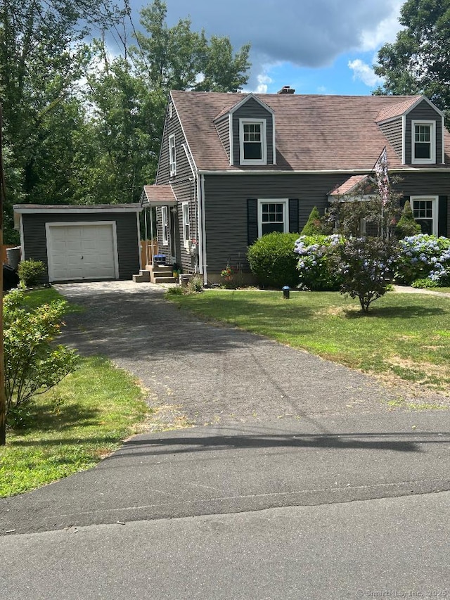 330 Dogburn Ln, Orange, CT 06477 - view of front facade with an attached garage, asphalt driveway, and a front lawn