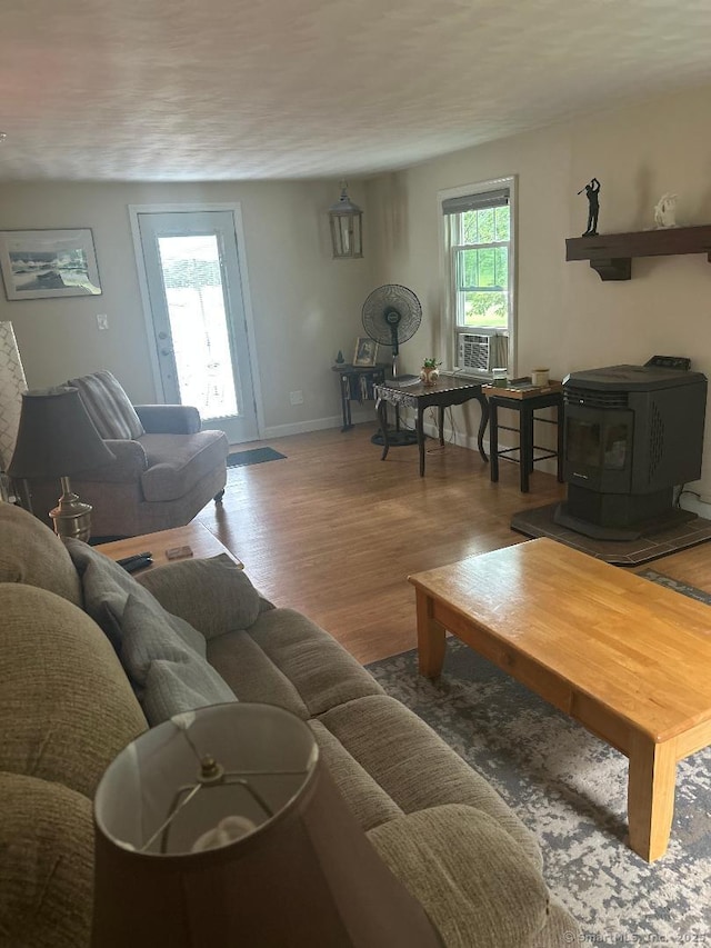 330 Dogburn Ln, Orange, CT 06477 - living area with a wood stove, wood finished floors, and cooling unit