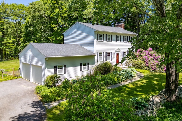318 Milton Rd, Litchfield, CT 06759 - colonial-style house featuring a chimney, asphalt driveway, roof with shingles, and a front yard