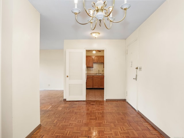 2600 Park Ave Unit 6H, Bridgeport, CT 06604 - unfurnished dining area featuring a chandelier and baseboards