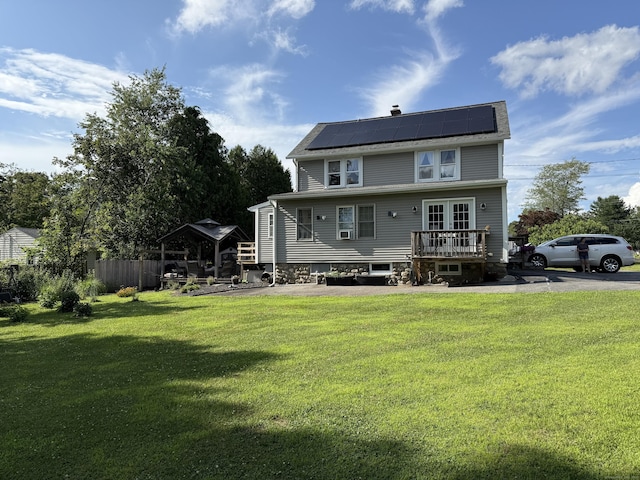 293 Torringford W St, Torrington, CT 06790 - rear view of house with solar panels, a wooden deck, and french doors