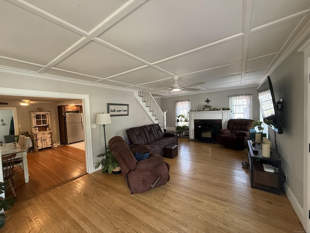 293 Torringford W St, Torrington, CT 06790 - living area with a ceiling fan, wood finished floors, a fireplace with flush hearth, coffered ceiling, and stairway