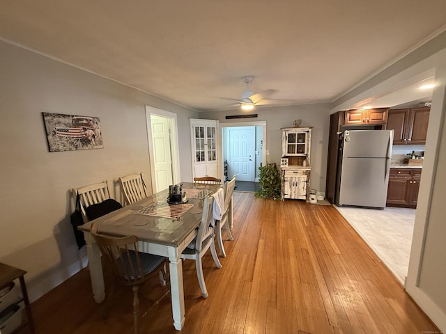 293 Torringford W St, Torrington, CT 06790 - dining space featuring a ceiling fan, light wood-style floors, and crown molding