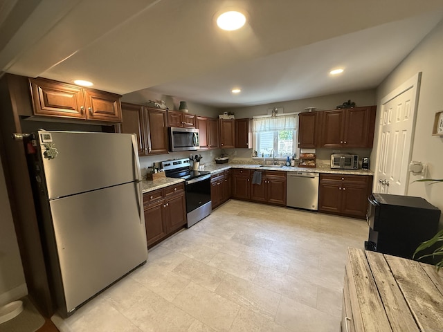 293 Torringford W St, Torrington, CT 06790 - kitchen with appliances with stainless steel finishes, recessed lighting, and light stone countertops