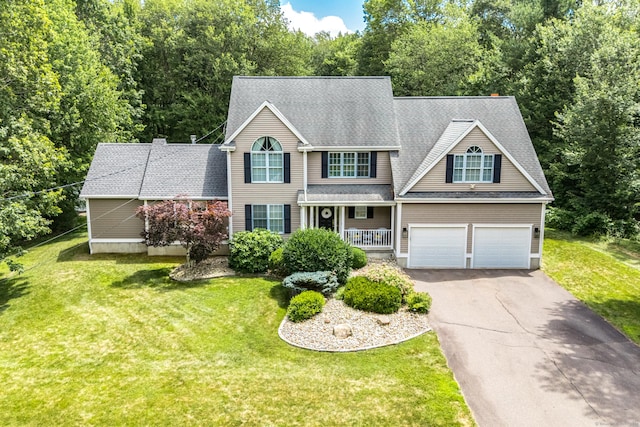 132 Deerwood Rd, Tolland, CT 06084 - view of front of house with driveway, an attached garage, a front yard, and roof with shingles