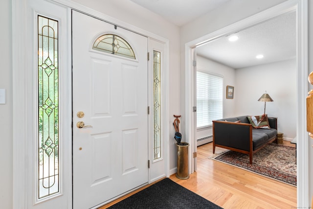 132 Deerwood Rd, Tolland, CT 06084 - foyer entrance with baseboard heating, plenty of natural light, light wood-type flooring, and recessed lighting