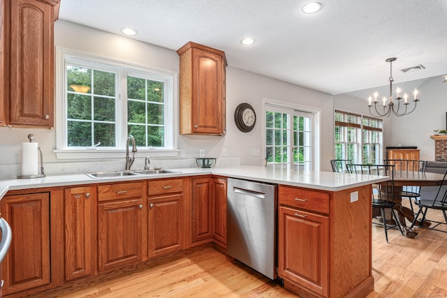 132 Deerwood Rd, Tolland, CT 06084 - kitchen featuring dishwasher, light wood-style flooring, a peninsula, brown cabinetry, and plenty of natural light