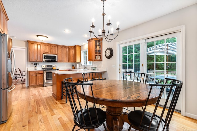 132 Deerwood Rd, Tolland, CT 06084 - dining space with light wood finished floors, healthy amount of natural light, recessed lighting, and a chandelier