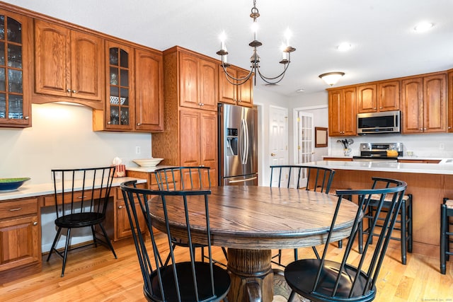 132 Deerwood Rd, Tolland, CT 06084 - kitchen with stainless steel appliances, brown cabinetry, light wood-style flooring, light countertops, and recessed lighting