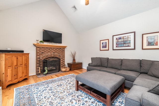 132 Deerwood Rd, Tolland, CT 06084 - living area with wood finished floors, a brick fireplace, and high vaulted ceiling