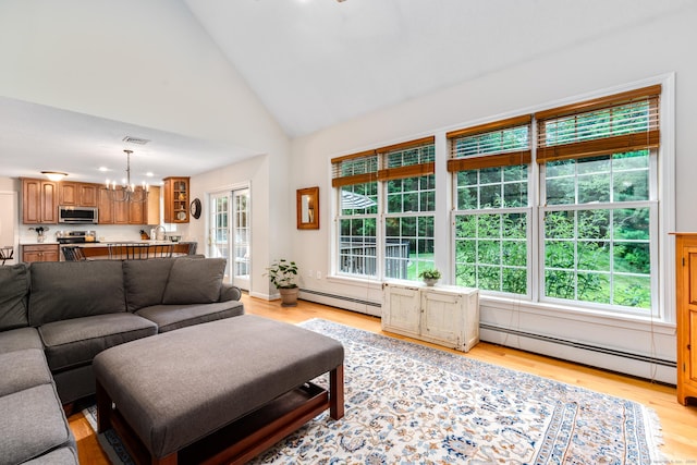 132 Deerwood Rd, Tolland, CT 06084 - living area with baseboard heating, a chandelier, light wood-type flooring, and high vaulted ceiling