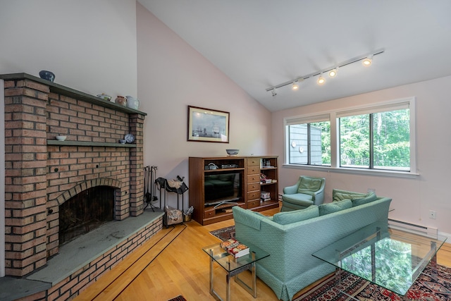 109 Old Farms Rd Unit 109, Torrington, CT 06790 - living room with wood finished floors, track lighting, lofted ceiling, a baseboard heating unit, and a fireplace