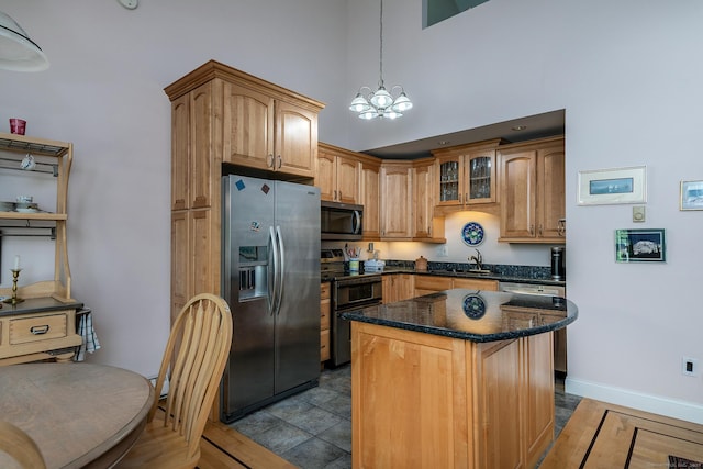 109 Old Farms Rd Unit 109, Torrington, CT 06790 - kitchen with stainless steel appliances, a chandelier, a center island, dark stone counters, and pendant lighting
