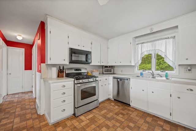 170 Celia Dr, Waterbury, CT 06705 - kitchen with appliances with stainless steel finishes, brick patterned floors, light countertops, and white cabinets