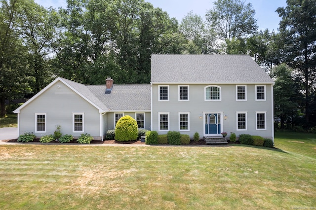 54 Round Hill Rd, Manchester, CT 06040 - colonial house with a chimney, a front lawn, a shingled roof, and view of scattered trees