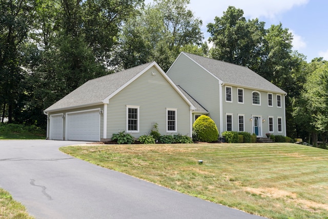 54 Round Hill Rd, Manchester, CT 06040 - colonial house with a garage, a front lawn, and view of wooded area
