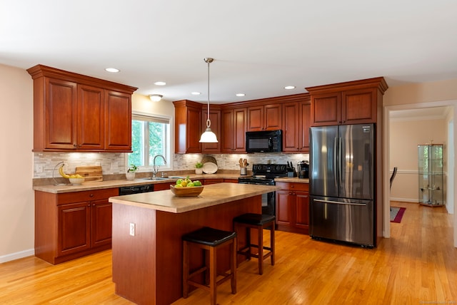 54 Round Hill Rd, Manchester, CT 06040 - kitchen featuring black appliances, light wood-type flooring, light countertops, decorative backsplash, and recessed lighting