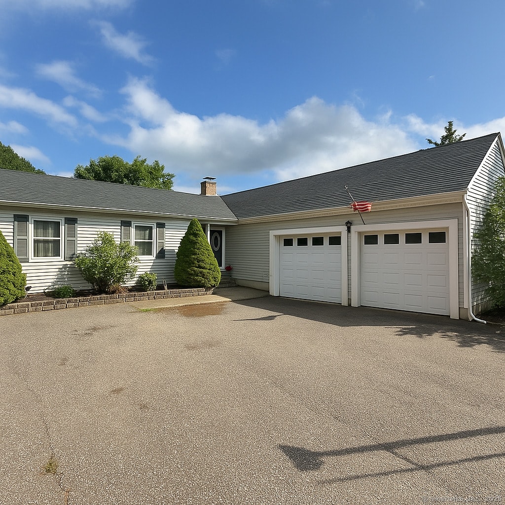 50 Mohegan Dr, Griswold, CT 06351 - ranch-style home with a garage, asphalt driveway, and a chimney