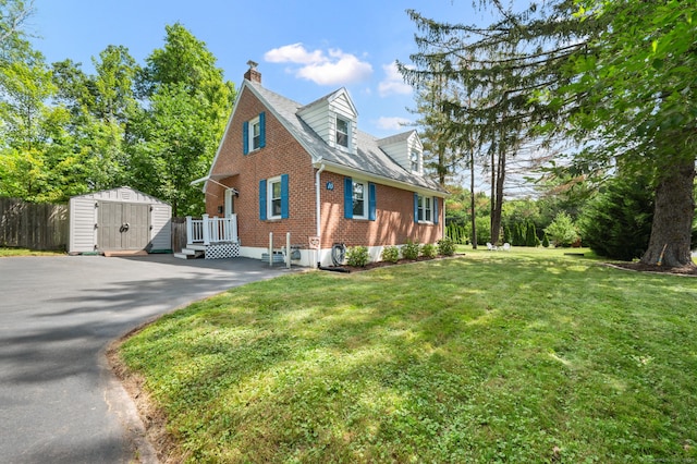 10 Harding Ave, Newington, CT 06111 - view of front facade featuring brick siding, a shed, a chimney, and driveway