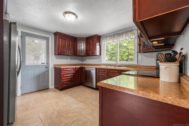 10 Harding Ave, Newington, CT 06111 - kitchen with appliances with stainless steel finishes, a textured ceiling, glass insert cabinets, and reddish brown cabinets
