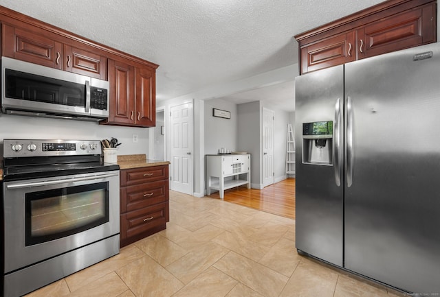 10 Harding Ave, Newington, CT 06111 - kitchen featuring appliances with stainless steel finishes, a textured ceiling, light tile patterned flooring, and light stone countertops