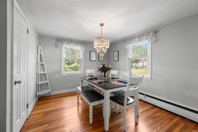 10 Harding Ave, Newington, CT 06111 - dining area featuring a baseboard heating unit, a chandelier, plenty of natural light, and light wood-style floors