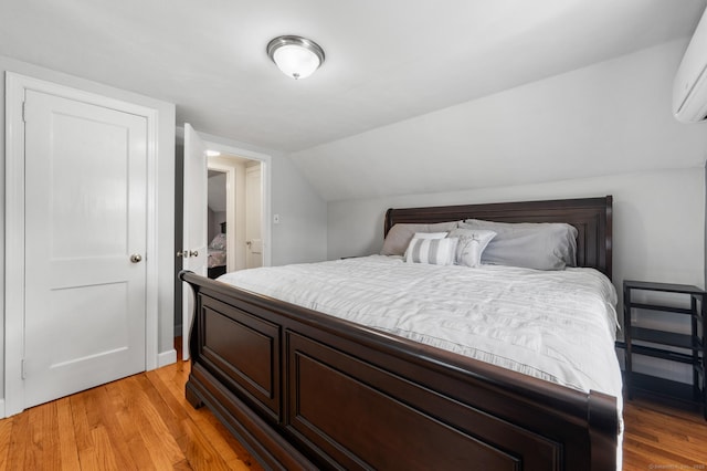 10 Harding Ave, Newington, CT 06111 - bedroom with light wood-style floors, a wall mounted air conditioner, and lofted ceiling