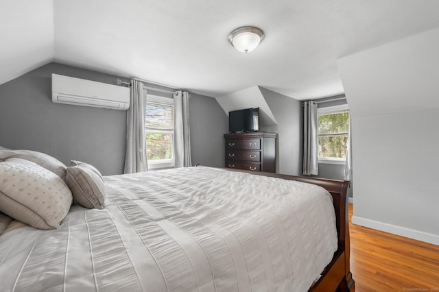 10 Harding Ave, Newington, CT 06111 - bedroom with an AC wall unit, vaulted ceiling, and wood finished floors