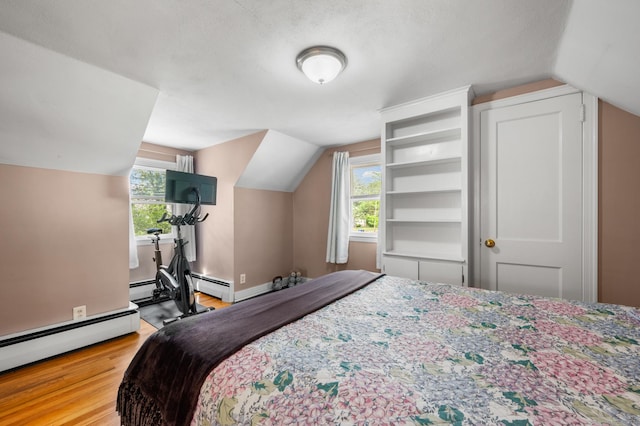 10 Harding Ave, Newington, CT 06111 - bedroom with wood finished floors, vaulted ceiling, and a baseboard heating unit