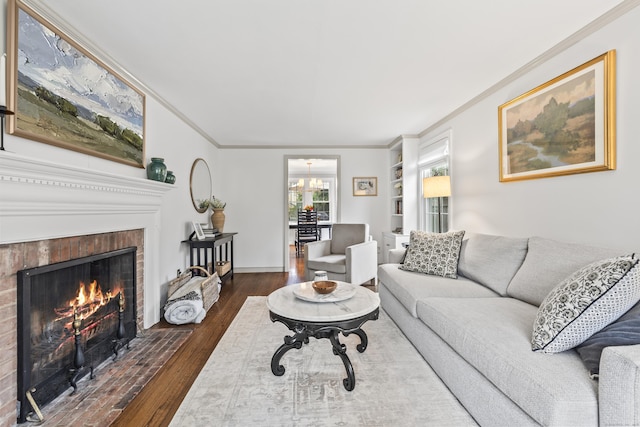 66 Concord St, West Hartford, CT 06119 - living area featuring ornamental molding, hardwood / wood-style flooring, a brick fireplace, and built in features