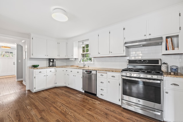 66 Concord St, West Hartford, CT 06119 - kitchen with appliances with stainless steel finishes, under cabinet range hood, dark wood-type flooring, white cabinets, and backsplash