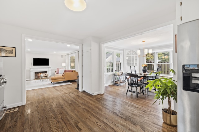 66 Concord St, West Hartford, CT 06119 - interior space with dark wood-style floors, recessed lighting, a warm lit fireplace, and a chandelier