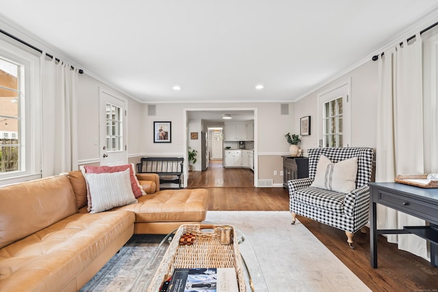 66 Concord St, West Hartford, CT 06119 - living area featuring healthy amount of natural light, wood finished floors, crown molding, and recessed lighting